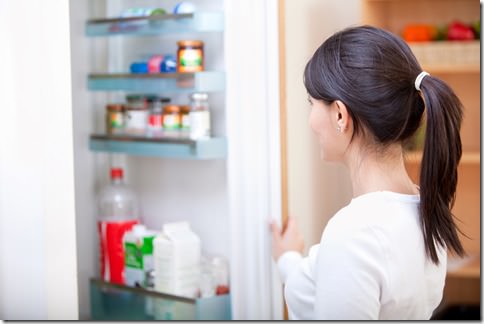 Woman looking inside the fridge