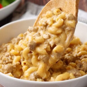 spoon putting homemade cheeseburger helper in a bowl