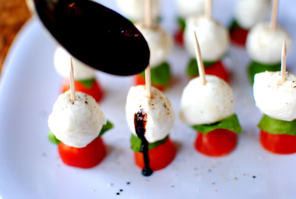 Drizzling caprese skewers with balsamic reduction