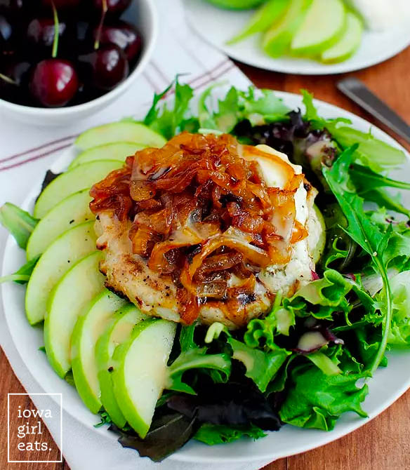 juicy turkey burger topped with caramelized onions on a salad