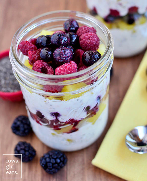 frozen berries on the top of a fruit and yogurt breakfast parfait