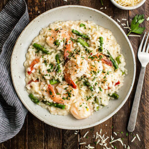 overhead photo of a bowl of shrimp and asparagus risotto