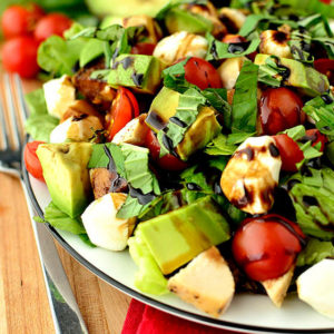 avocado and chicken caprese salad on a plate