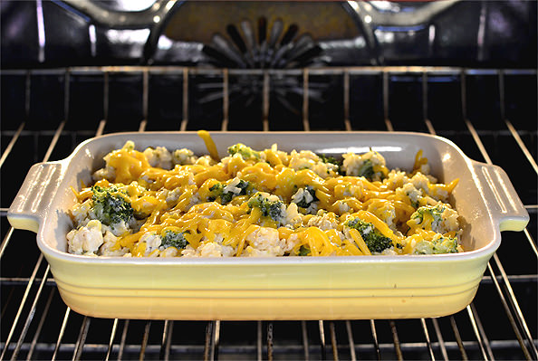 Dish of healthy cheesy chicken rice casserole in oven