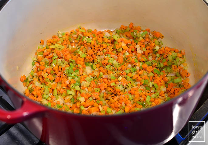 minced vegetables being sauteed in a dutch oven