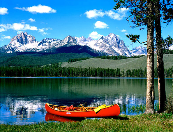 Sawtooth National Recreation Area of Idaho where a red canoe is beached on the shores of Little Redfish Lake