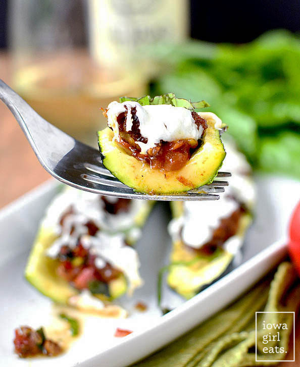 Italian Tomato-Basil Stuffed Zucchini is a light and low-carb, gluten-free summer dinner recipe. Simple and satisfying. | iowagirleats.com