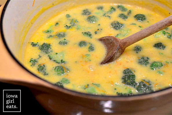 spoon stirring a pot of broccoli cheddar soup