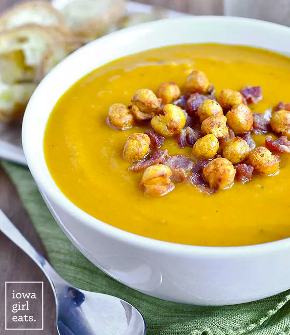 roasted butternut squash soup in a bowl with bacon and crispy chickpeas