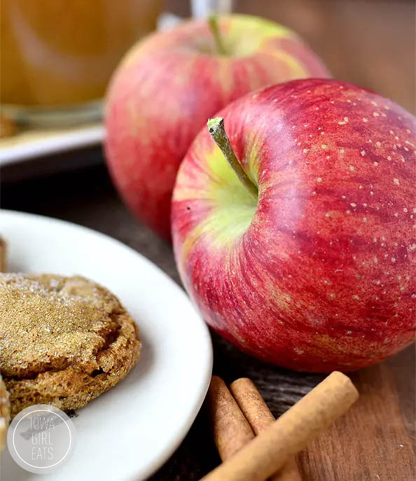 apples sitting with a plate of cookies