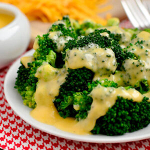 easy cheese sauce over broccoli with a fork