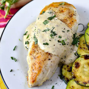 chicken breast with a creamy herb sauce drizzled on top