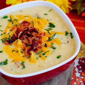 bowl of Bacon-Cheddar Cauliflower Chowder with shredded cheese and bacon on top