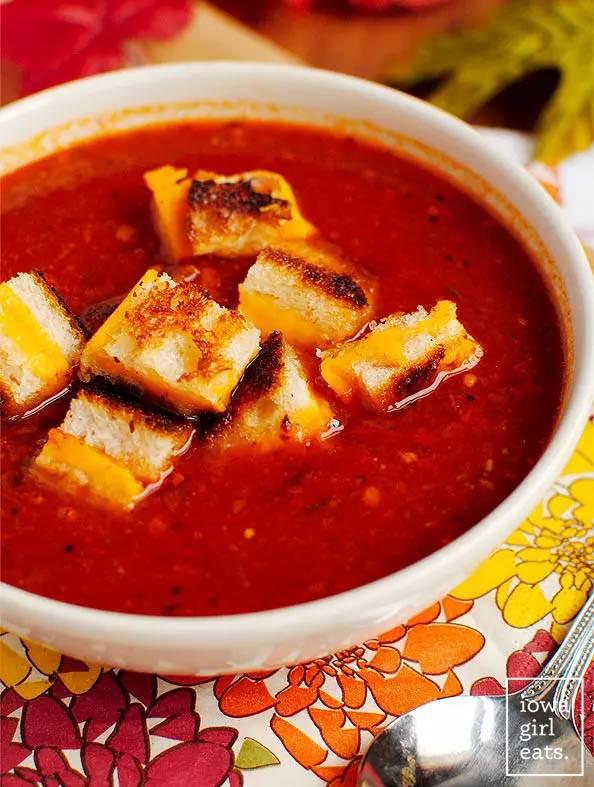 bowl of roasted tomato soup with grilled cheese croutons on top