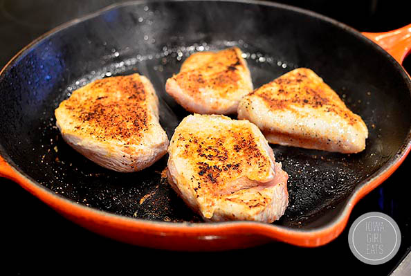 chicken breasts sauting in a skillet