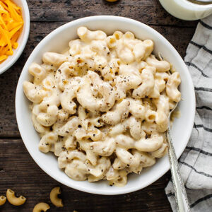 creamy gluten free mac and cheese in a bowl with a fork