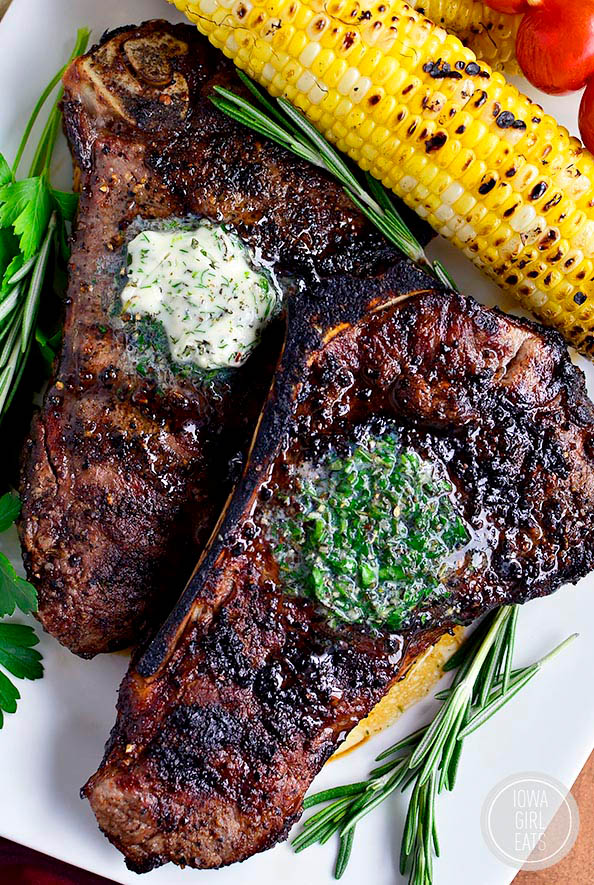 Two perfect grilled steaks with herb butter