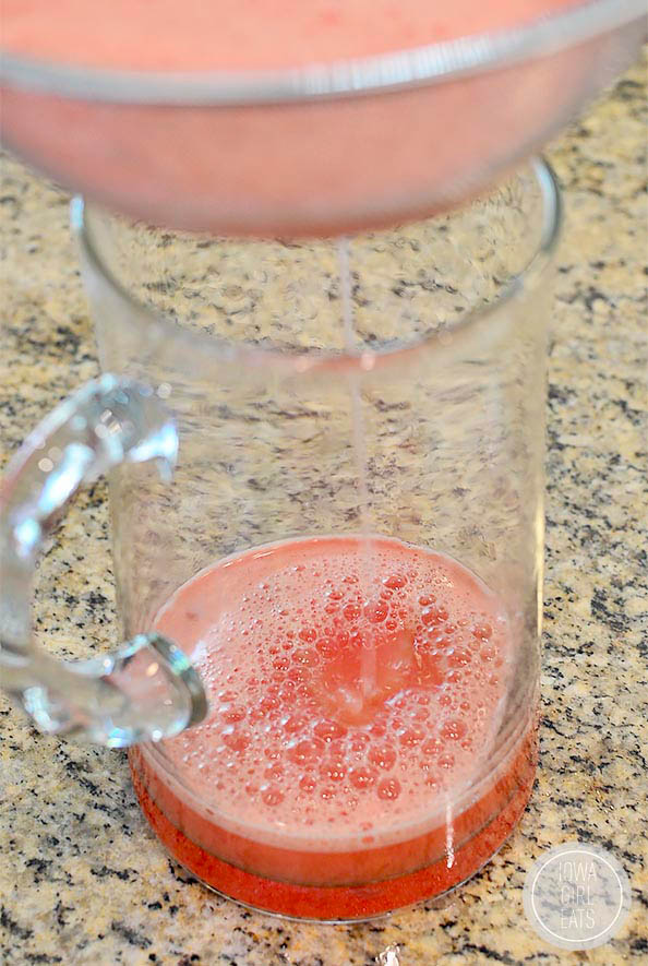 watermelon juice inside of a glass pitcher