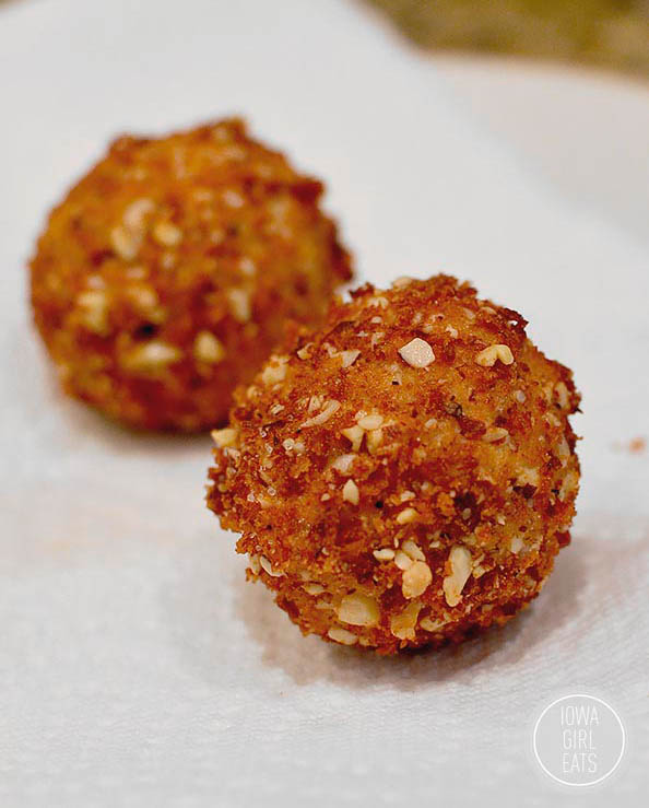 fried goat cheese balls draining on a paper towel