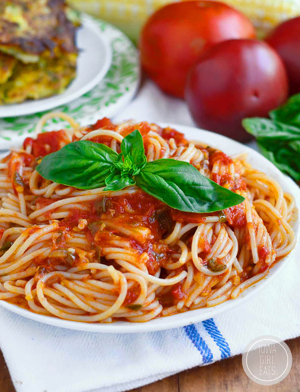 spaghetti al pomodoro on a plate with basil
