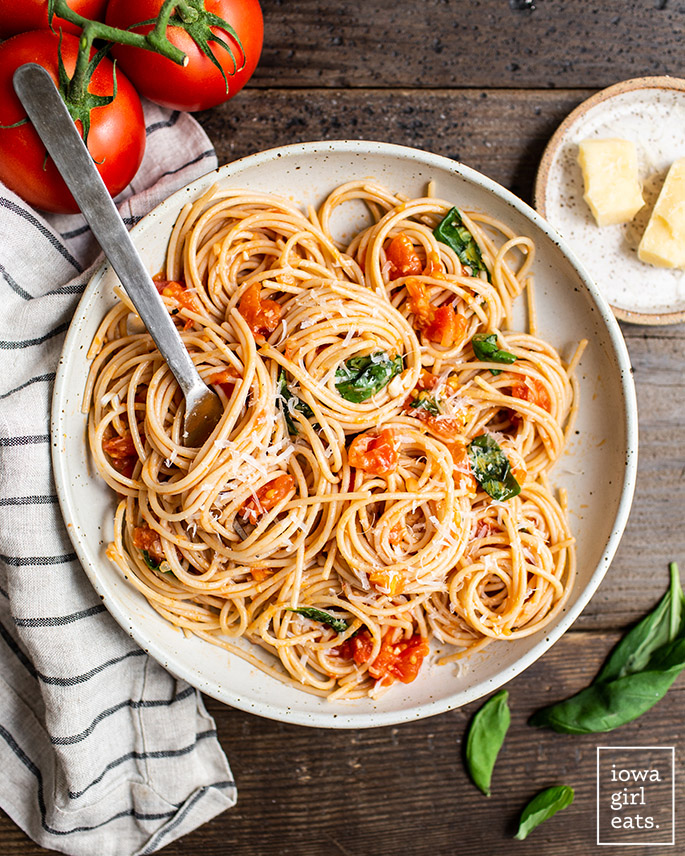 overhead photo of a fork in a plate of spaghetti al pomodoro