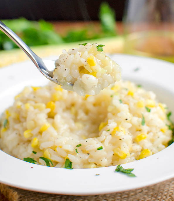spoon scooping up sweet corn risotto