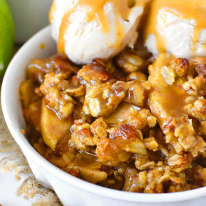 caramel apple crisp with easy caramel sauce and ice cream in a dish
