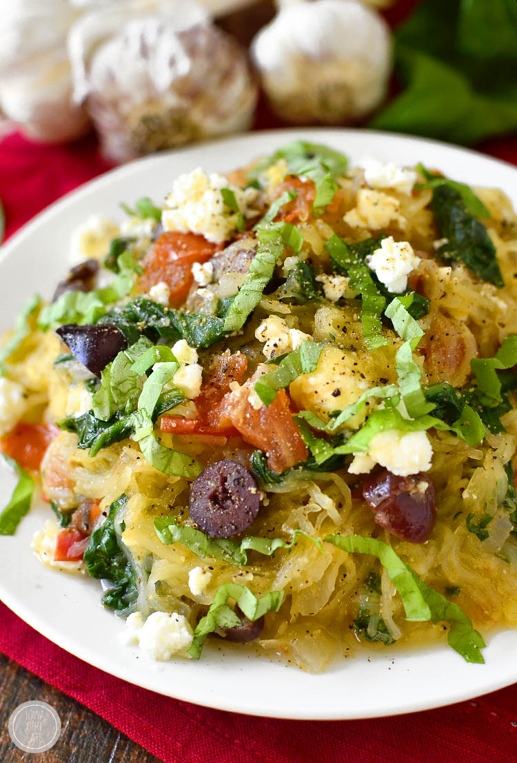 Very-Veggie Spaghetti Squash is a healthy meal packed with vegetables accented with pops of salty cheese and kalamata olives. Fresh and filling! | iowagirleats.com