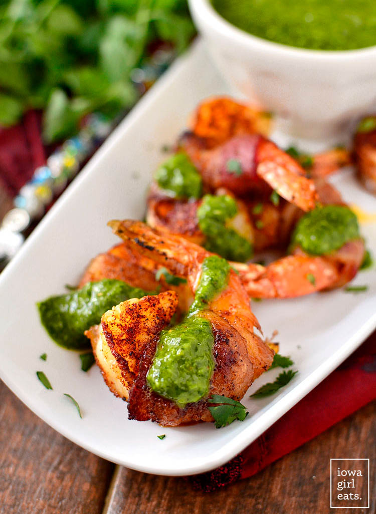 bacon wrapped bbq shrimp with chimichurri sauce on top