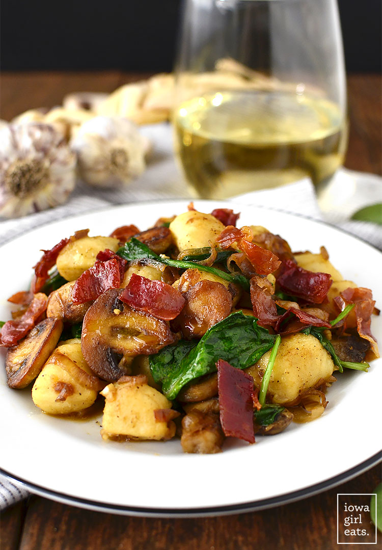 Get your forks ready - you'll be fighting over every last bite of Gnocchi with Spinach, Mushrooms and Crispy Prosciutto. This 30 minute, gluten-free meal is a stunner! | iowagirleats.com