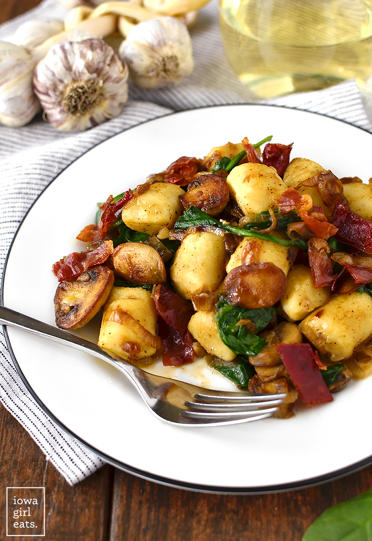 Get your forks ready - you'll be fighting over every last bite of Gnocchi with Spinach, Mushrooms and Crispy Prosciutto. This 30 minute, gluten-free meal is a stunner! | iowagirleats.com