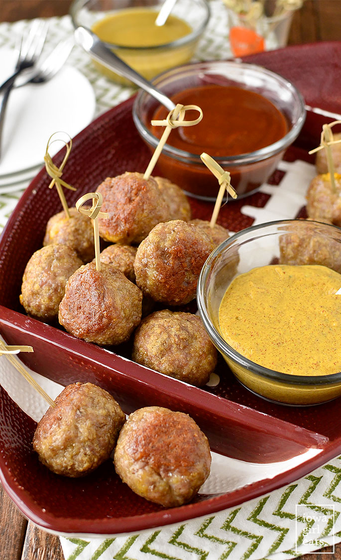 Cheddar Brat Meatballs are homemade bratwurst stuffed with gooey cheddar cheese. Serve with three, easy flavor-packed dipping sauces! #glutenfree | iowagirleats.com