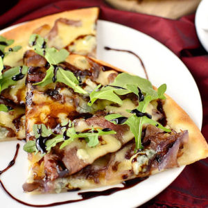 Gluten-Free Steak House Pizza is loaded with steak house favorites like buttery steak, caramelized onions, balsamic reduction, and two types of cheeses! | iowagirleats.com