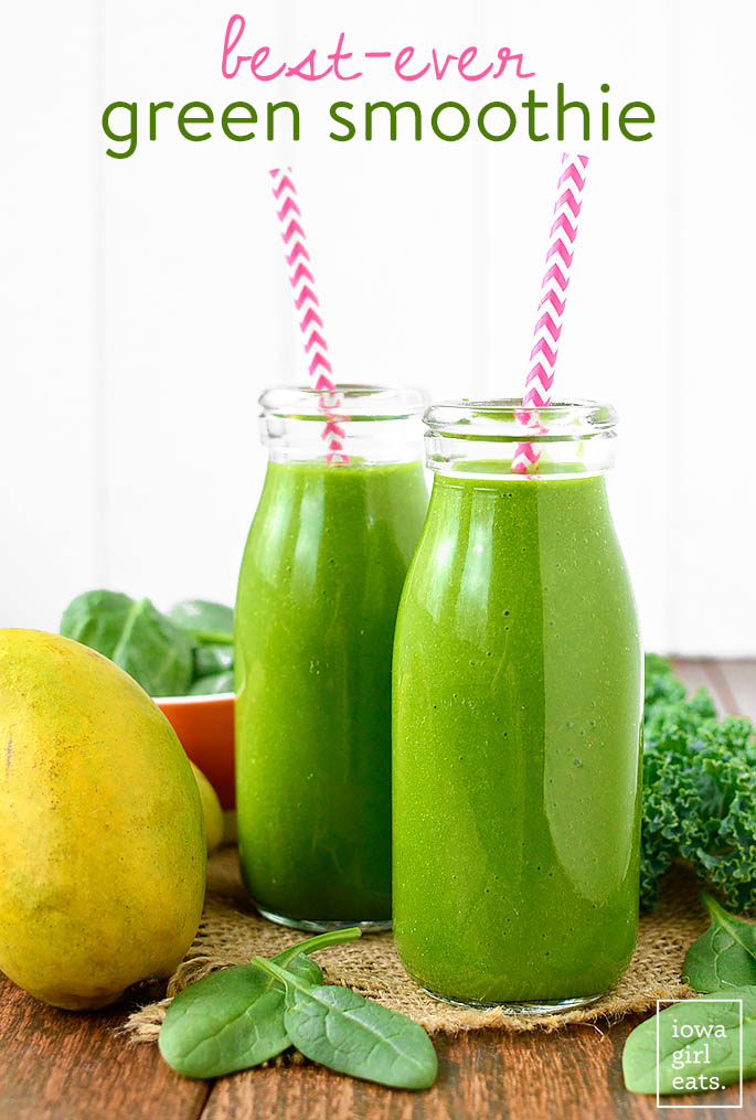mango spinach smoothies in glass jars with straws