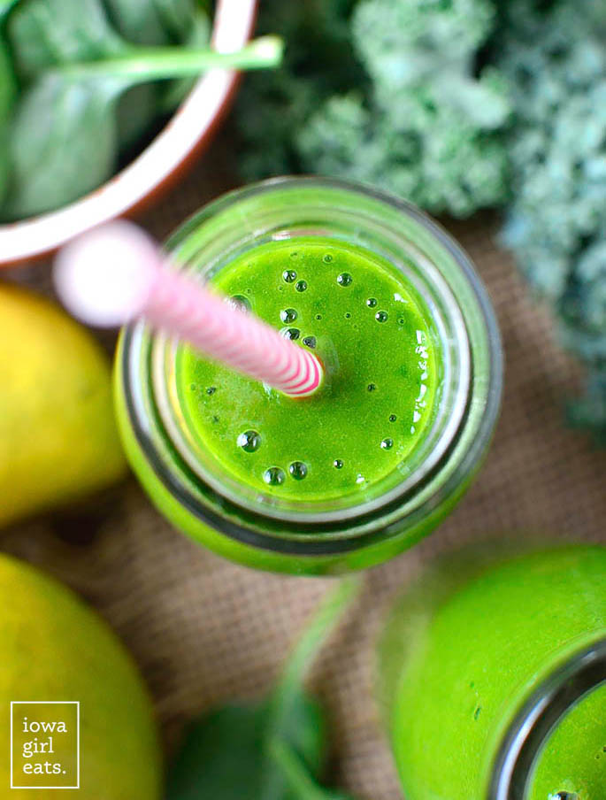 overhead photo of mango spinach smoothie in a jar