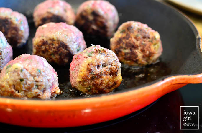homemade meatballs sauting in a hot skillet