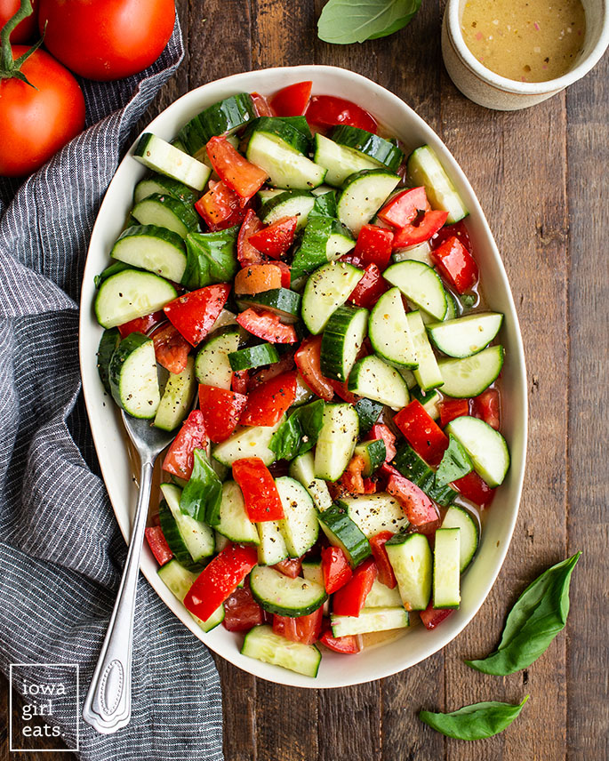 overhead photo of cucumber tomato salad in a bowl