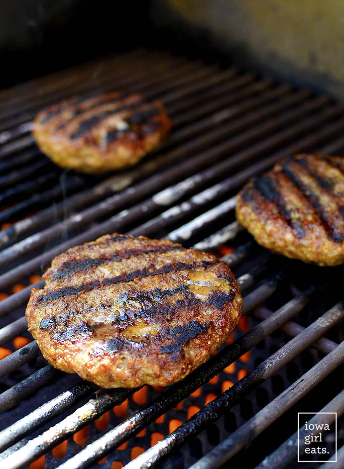Homemade Brat Burgers with Gluten-Free Beer-Braised Caramelized Onions is homemade brat mixture (just pork and spices,) topped with luscious, gluten-free beer-spiked onions. You'll be making this grilling recipe all summer long! | iowagirleats.com