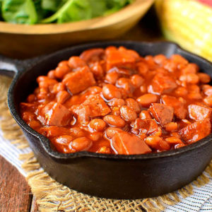 crock pot baked beans in a cast iron skillet