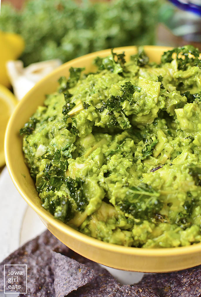 Kale and Artichoke Guacamole is a lighter twist on guacamole and spinach and artichoke dip, and is full of superfoods like kale and avocado. The perfect gluten-free + vegan dip recipe for any occasion! | iowagirleats.com