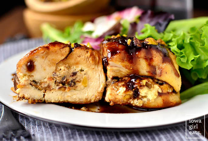 fig and goat cheese stuffed chicken breast cut in half drizzled with sauce