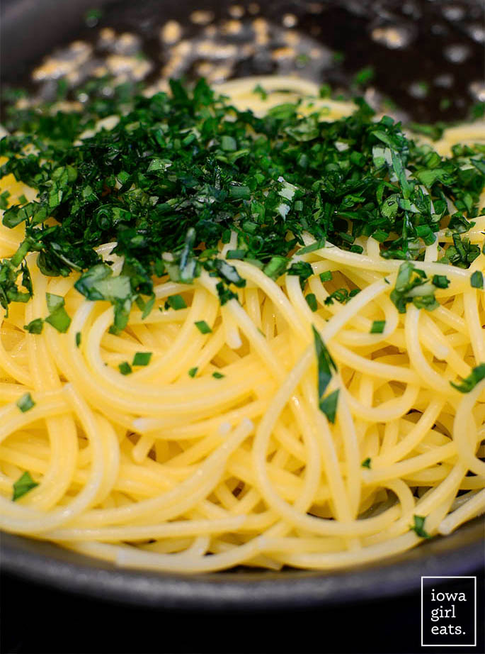 pasta with garlic, butter and dried herbs in a skillet