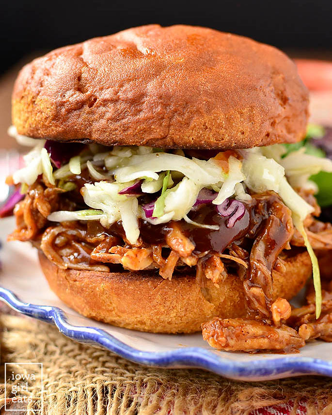 slow cooker pulled pork on a bun with coleslaw