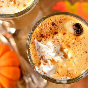 2 glasses of homemade pumpkin spice latte with whipped cream and cinnamon