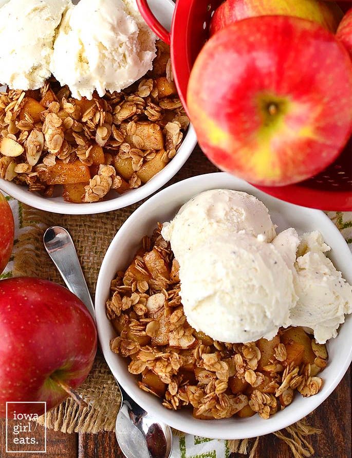 overhead photo of apple crisp in bowls with ice cream scoops