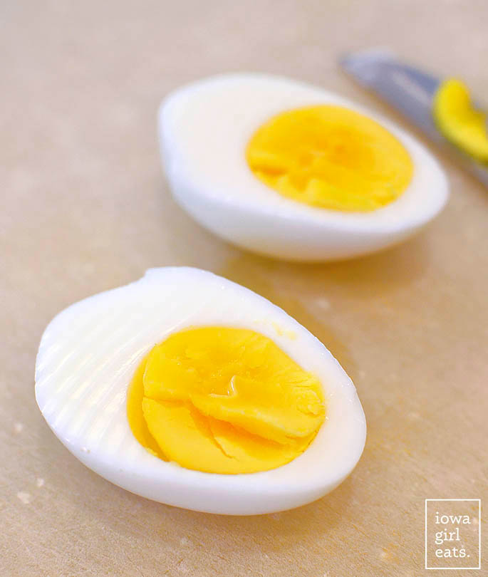 hard boiled eggs sliced in half on a cutting board