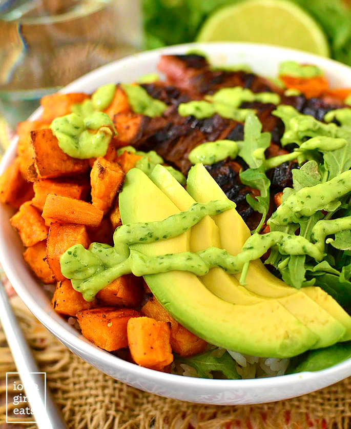 avocado slices over rice with steak and sweet potatoes