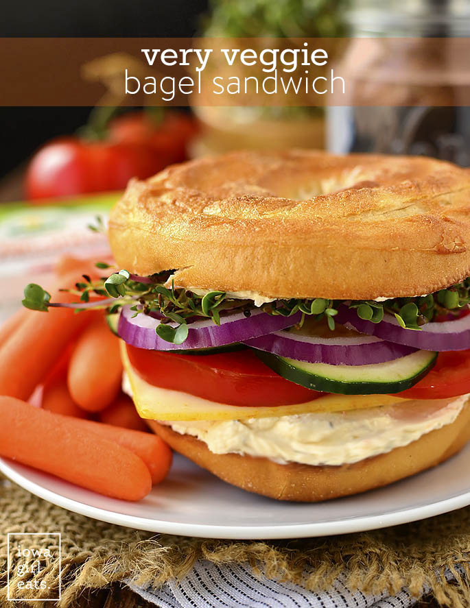 Very Veggie Bagel Sandwich is stuffed with fresh vegetables, herb and spice cream cheese, and mild muenster cheese. A healthy and satisfying breakfast or lunch idea! | iowagirleats.com