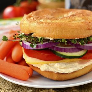 Very Veggie Cheese and Bagel Sandwich is stuffed with fresh vegetables, herb and spice cream cheese, and mild muenster cheese. A healthy and satisfying breakfast or lunch idea! | iowagirleats.com