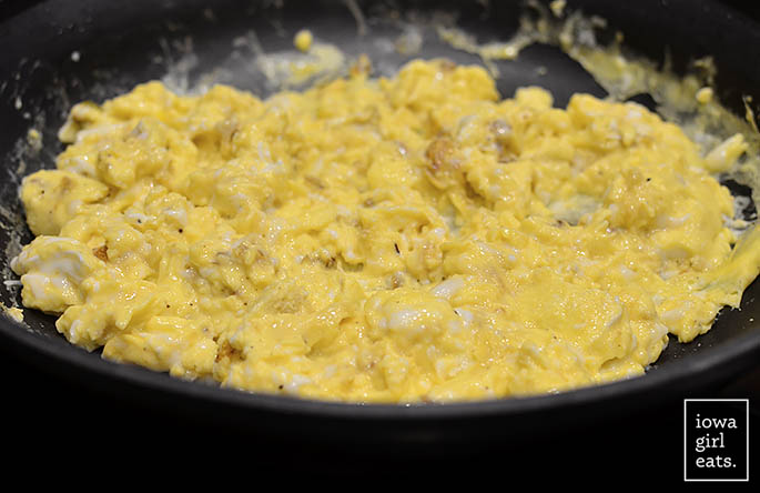 eggs scrambling in a hot skillet
